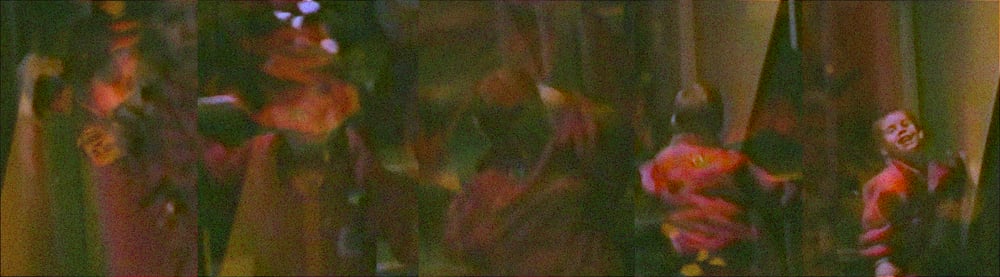 Five tall frames of home video side by side: a small child in red moves through a dim room lit warm green and amber, turning and laughing in the last two. Heavy colored grain covers the whole strip.
