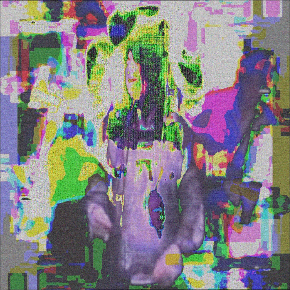Medium-long shot high angle of Anohni Hegarty singing on stage. Blobs and splotches of white yellow magenta lime and blue distort the entire image.