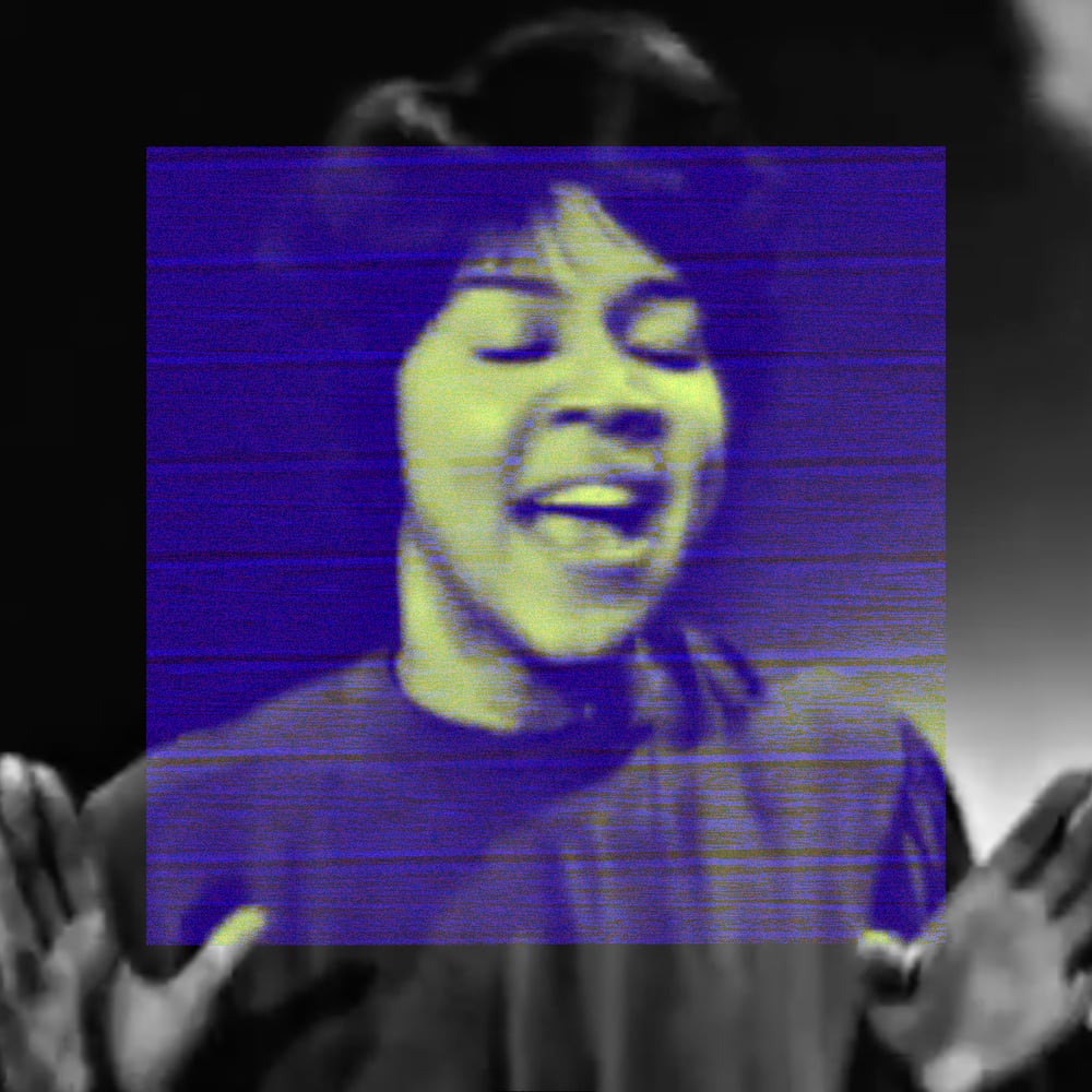 A close-up of Mavis Staples singing with her mouth open, eyes closed, hands raised open at shoulder height. The outer image is dark grayscale. A large deep indigo-blue square covers the center, with yellow-green coloration visible on her face and skin within it.